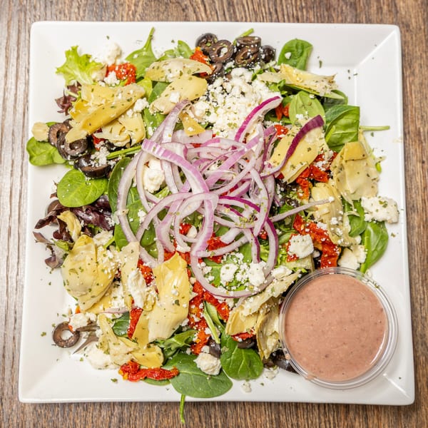 Celestino's Pizza & Pasta's fresh salad with spinach, artichoke hearts, feta, olives, red onion, and sun-dried tomatoes.