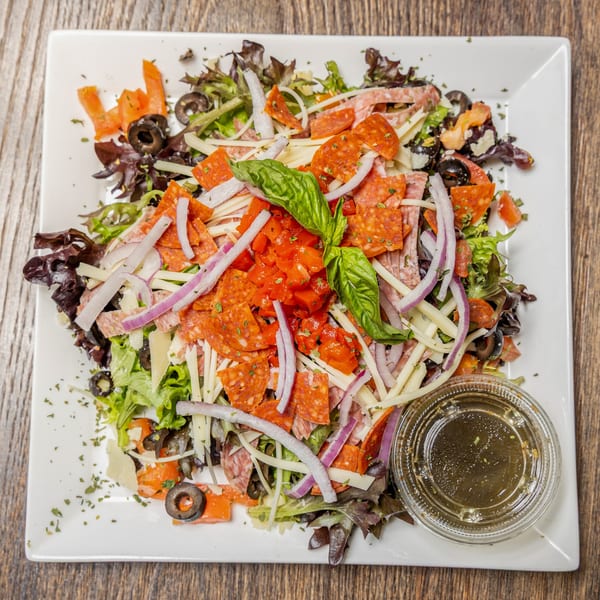 Celestino's Pizza & Pasta's antipasto salad with pepperoni, salami, cheese, olives, and dressing.